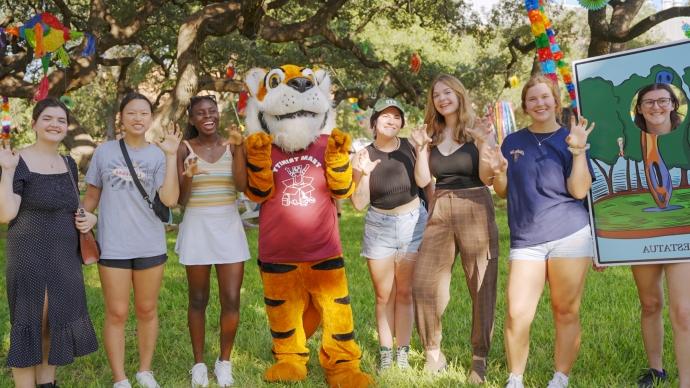 A group of 7 women students pose with the LeeRoy Tiger mascot