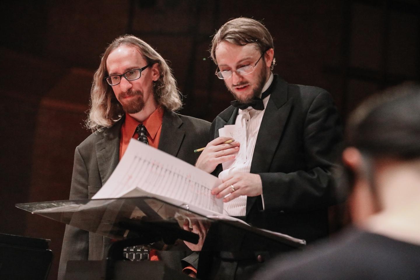 Two conductors reading music