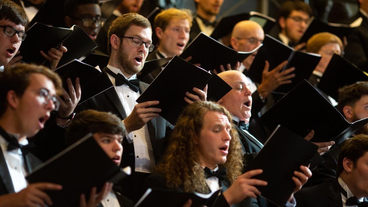 Choir students singing together during a concert