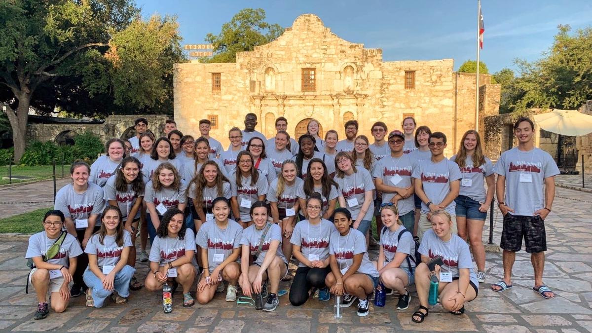 Students posing in front of the Alamo
